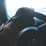 person holding black steering wheel
