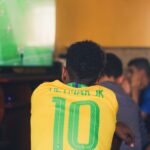 man wears yellow and green jersey shirt