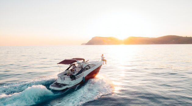 man riding on white and red boat on sea during daytime