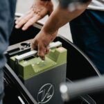 person holding black and green electronic device