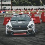 black and white car turning left on race track