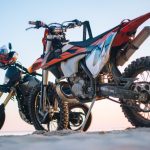 selective focus photography of two white and black dual-sport motorcycles