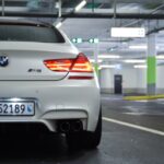 white bmw m 3 on road during daytime