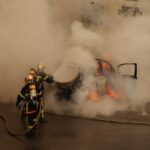 man riding on motorcycle with smoke coming from it