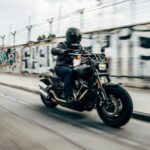 person riding motorcycle on concrete road