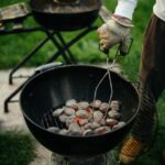 person cooking meat on black round pan