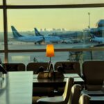white table and chairs near glass window