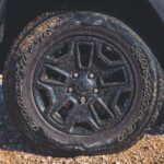 black vehicle wheel with Wrangler tire