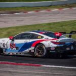 white and blue coupe on road