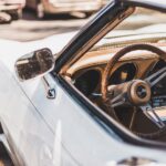 white vehicle parks on road during daytime