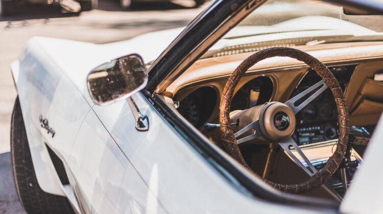 white vehicle parks on road during daytime