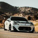 white and black porsche 911 on road during daytime