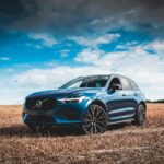 blue bmw m 3 coupe on brown field under blue and white sunny cloudy sky during