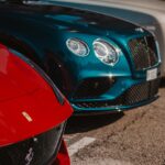 three assorted-color-and-brand vehicles