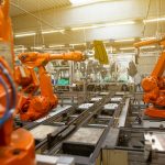 a factory filled with lots of orange machines