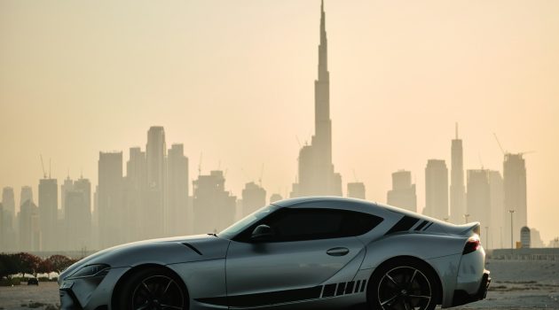 gray porsche 911 on road near city buildings during daytime
