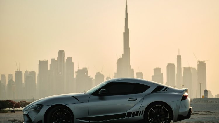 gray porsche 911 on road near city buildings during daytime